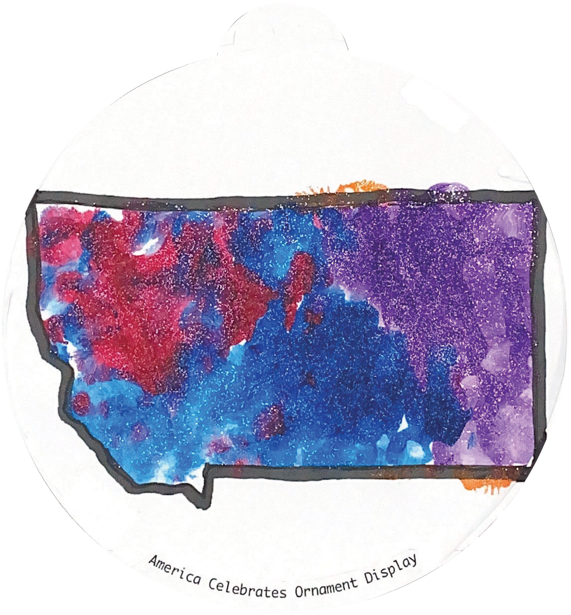 ornament depicting the outline of the state of Montana, filled in with sparkly blue, red, and purple glitter